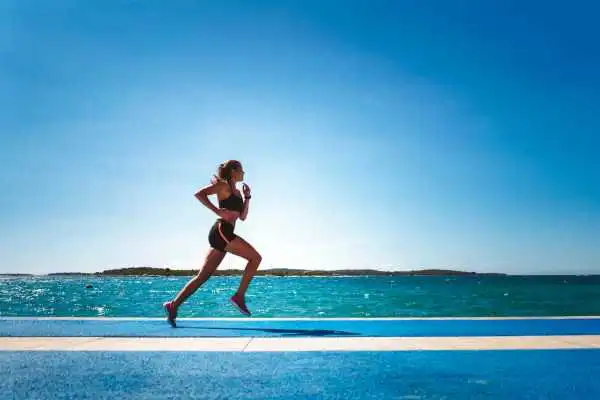 Woman running showing strong leg muscle Earley